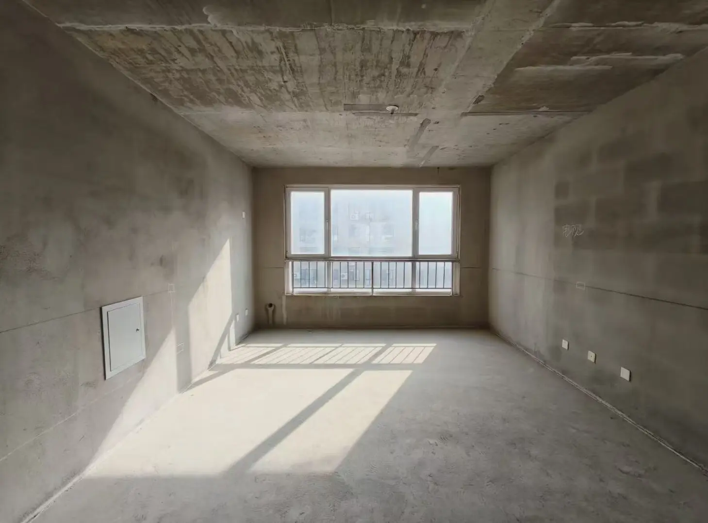 Before: bare concrete room