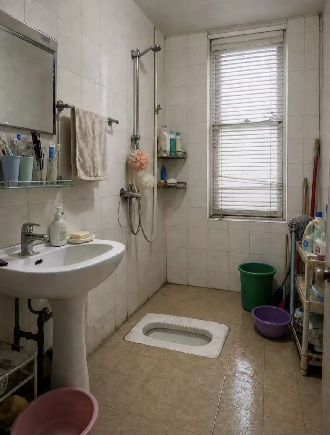 Before: dated old bathroom with a squat toilet